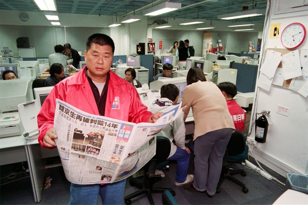 Jimmy Lai reading a copy of his newspaper in the Apple Daily newsroom on December 15, 1995. Photo: SCMP