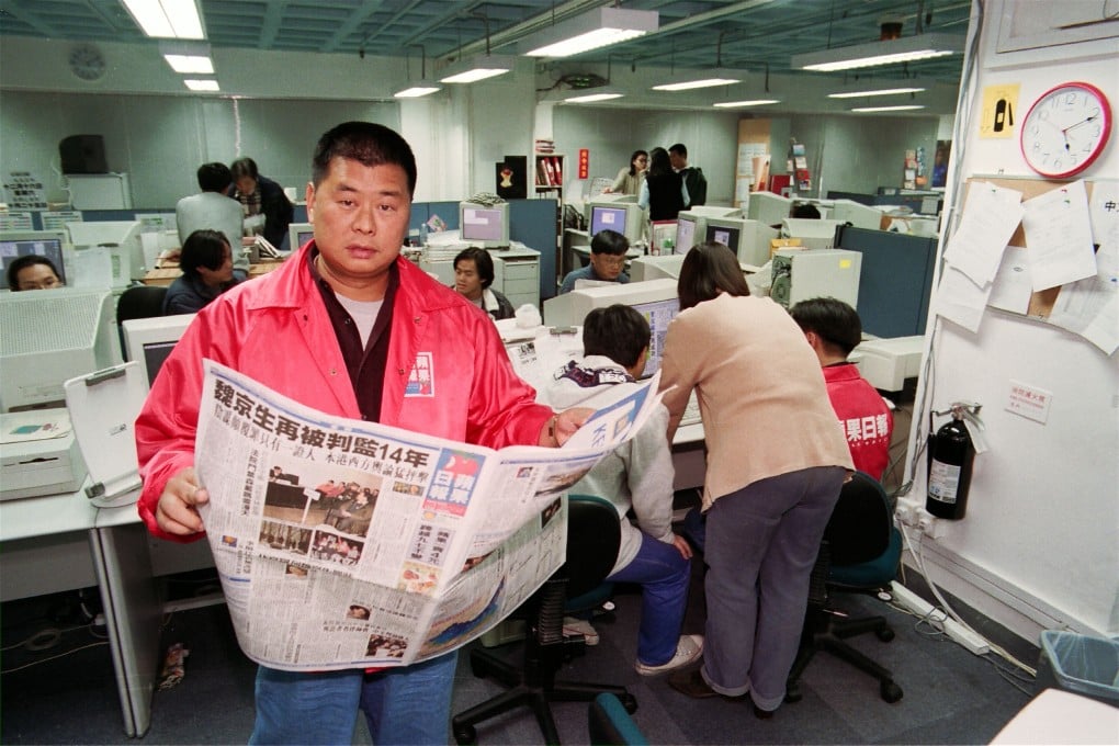 Jimmy Lai reading a copy of his newspaper in the Apple Daily newsroom on December 15, 1995. Photo: SCMP
