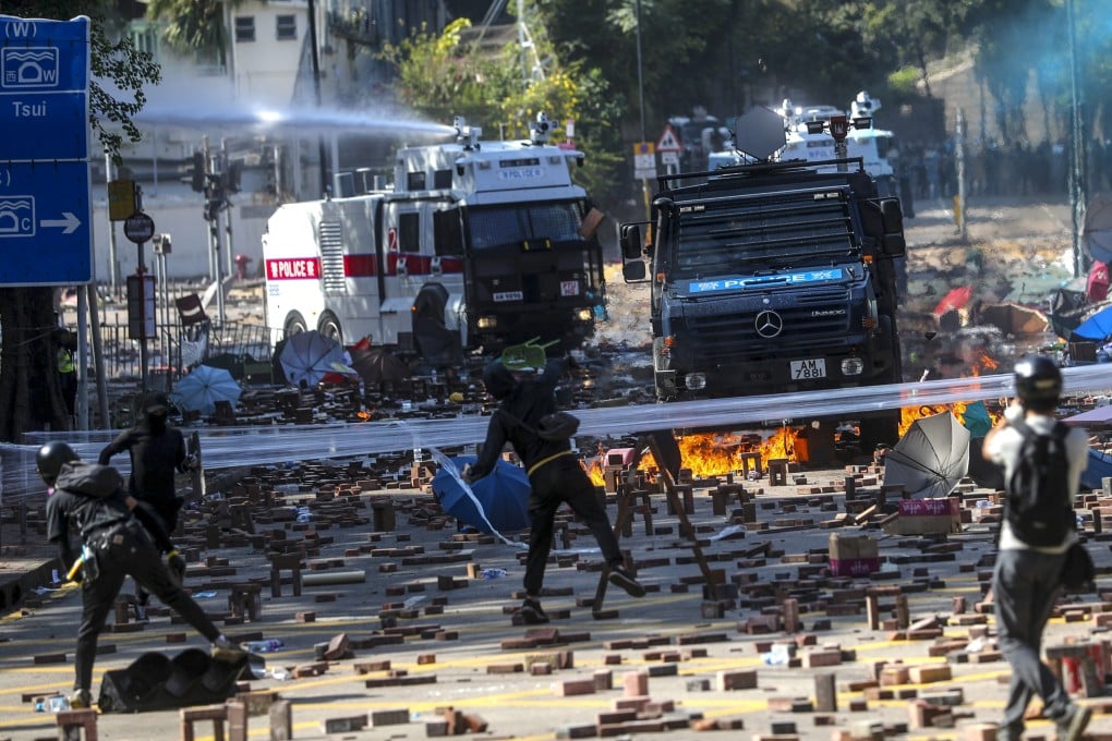 Two water cannon and an armoured vehicle arrive as clashes break out between riot police and students near Polytechnic University on November 17, 2019. Photo: Sam Tsang