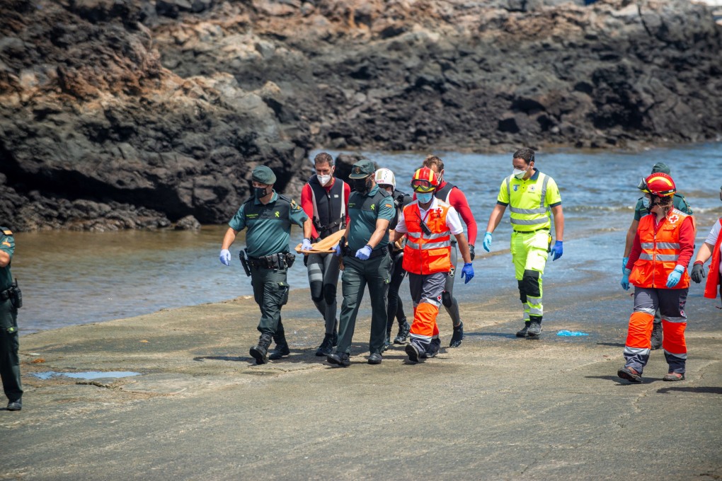 Emergency workers and Civil Guard staff retrieve the lifeless body of a minor in Orzola, Lanzarote, Canary Islands, Spain on Friday. Photo: EPA-EFE
