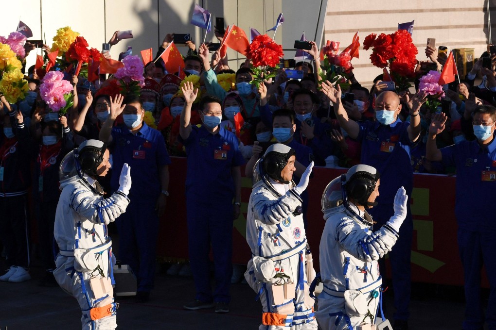 Astronauts (from left) Tang Hongbo, Liu Boming and Nie Haisheng head to a bus before boarding the Shenzhou-12 at a launch centre in the Gobi Desert on Thursday. They are to spend three months at China’s new space station. Photo: AFP