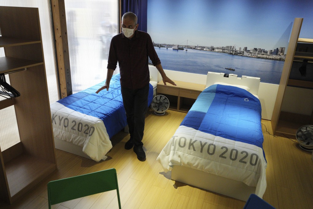 A journalist looks at cardboard beds at the Olympic Village in Tokyo on June 20, 2021. Photo: AP