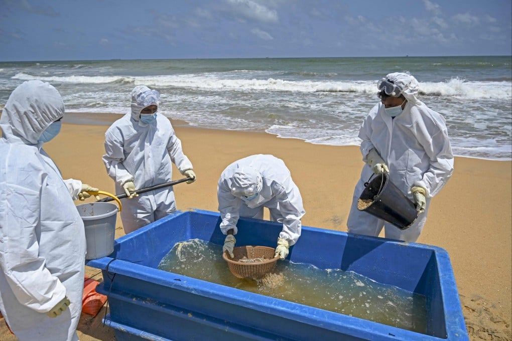 Members of the Sri Lankan Navy work to remove debris washed ashore from the Singapore-registered container ship MV X-Press Pearl, which sank after burning for almost three weeks in the sea off Colombo Harbour. Photo: AFP