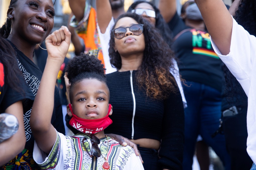 A boy raises his fist during an event on Juneteenth in New York City on Saturday. Photo: Reuters