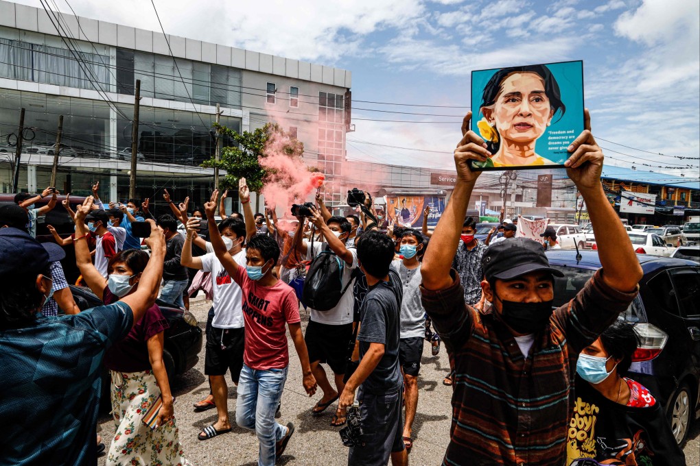 A protester holds up a painting of Myanmar’s detained civilian leader Aung San Suu Kyi in Yangon, Myanmar on Saturday. Photo: AFP