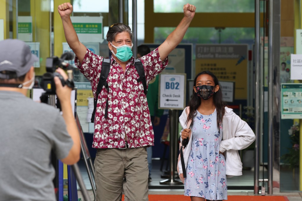 A man and girl exit a community vaccination centre in Sai Ying Pun on June 14. To boost the vaccination rate, several companies have launched lucky draws for the fully vaccinated. Photo: Nora Tam