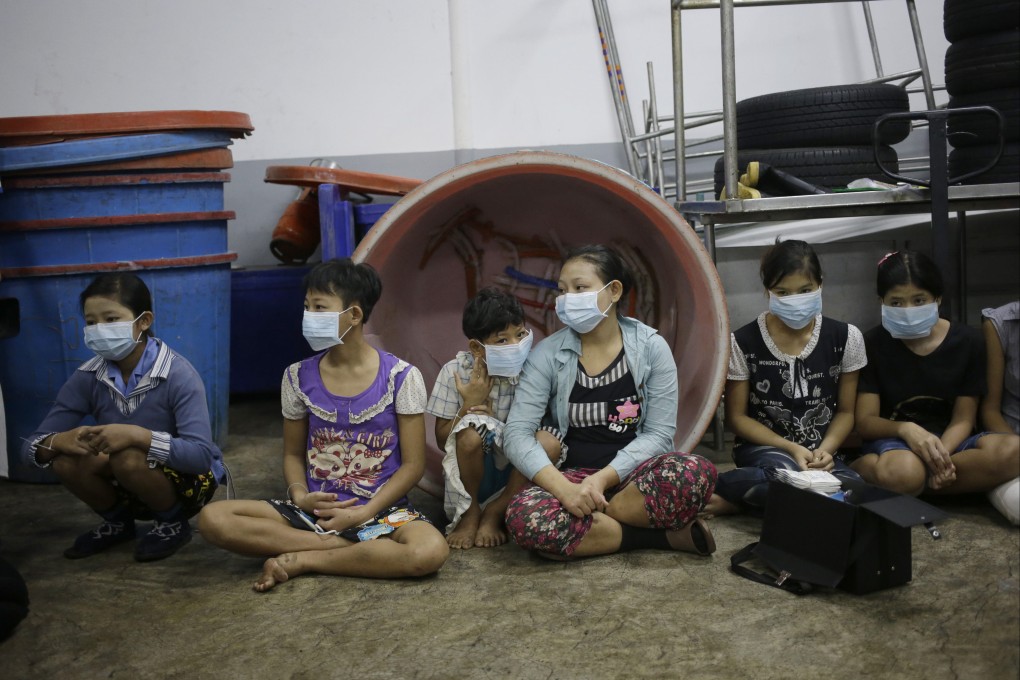 Children sit during a raid on a shrimp shed in 2015 in Samut Sakhon, Thailand, where forced labour has been a known issue. The pandemic has disrupted supply chains, creating opportunities for human traffickers to fill the void with victims. Photo: AP