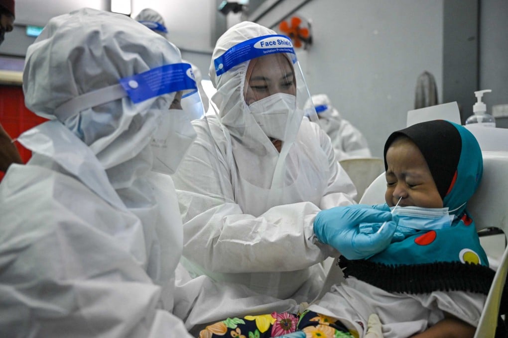 A medical worker tests a child at a free Covid-19 testing site in Shah Alam, on the outskirts of Kuala Lumpur, Malaysia. Photo: AFP