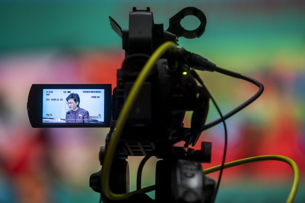 Chief Executive Carrie Lam Cheng Yuet-ngor is seen through a camera viewfinder as she addresses a news conference on June 21 in Hong Kong. The city is set to shorten hotel quarantine to seven days for fully vaccinated residents and non-residents travelling from most places, subject to conditions, but the 21-day quarantine remains for the rest. Photo: Bloomberg