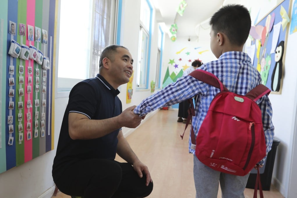 Wu Liangsheng, director for education research at the Beijing Stars and Rain Education Institute for Autism, greets a student at one of the school’s centres. Photo: Simon Song