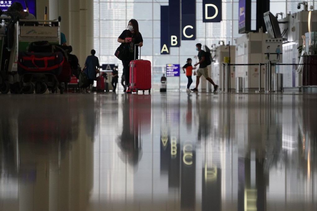 A woman wheels a suitcase at Hong Kong International Airport on June 30. If we don’t open our borders together with everyone else, Hong Kong risks getting left behind socially and economically. Photo Felix Wong