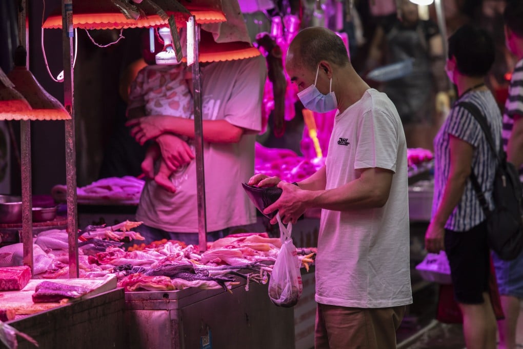 Chinese shop at an open-air market in Guangzhou on May 24. Pork is central to Chinese cuisine and culture. Photo: Bloomberg