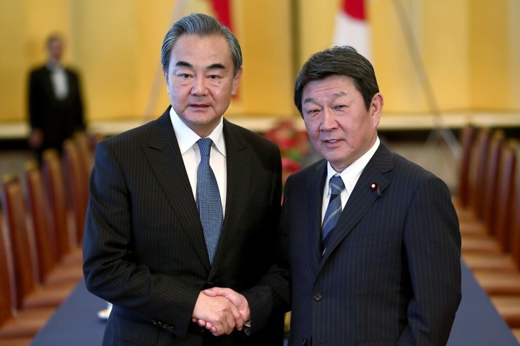 Chinese Foreign Minister Wang Yi (left) shakes hands with his Japanese counterpart Toshimitsu Motegi prior to a meeting in Tokyo on November 25. 2019. Photo: AP