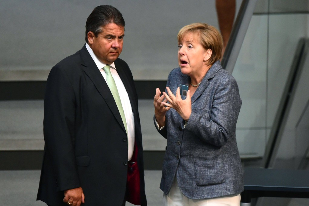 German Chancellor Angela Merkel (right) talks with then German vice-chancellor Sigmar Gabriel during a debate ahead of a vote on a third bailout for debt-mired Greece at the German lower house of parliament in Berlin in August 2015. Photo: AFP