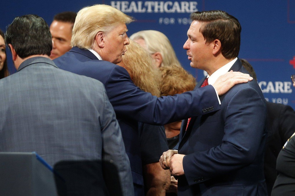 Then president Donald Trump (left) talks to Florida Governor Ron DeSantis after giving a speech to his supporters in Florida on October 3, 2019. Photo: Tampa Bay Times  /TNS