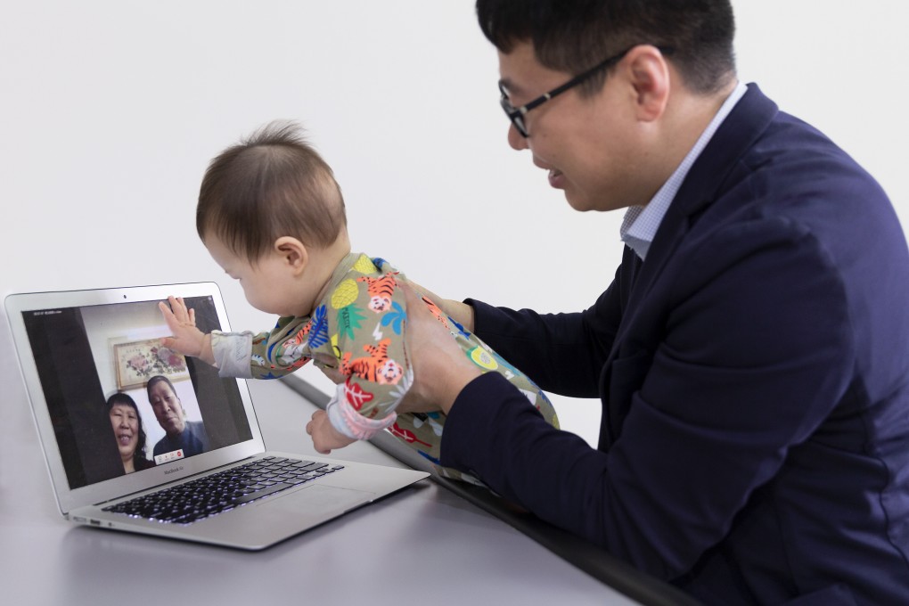 University of Sydney researcher Zhanwei Hou holds his son Baoxi during a video call with his parents, who have been unable to visit their first grandchild because of the pandemic. Photo: The University of Sydney / Louise M Cooper