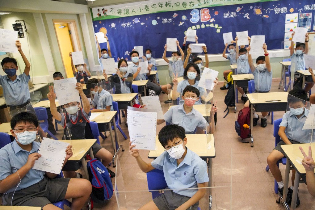 Primary school students with papers certifying their Form One placement, in Kowloon on July 6. Photo: Winson Wong