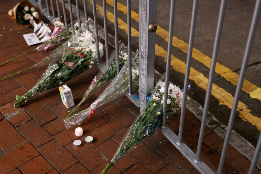 Flowers seen placed on a metal fence on July 2 as a tribute to a man who stabbed a police officer and then fatally knifed himself in the chest the previous day, the 24th anniversary of Hong Kong’s return to Chinese sovereignty. Photo: Reuters