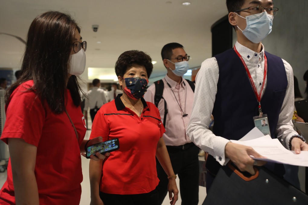A staff member attends to potential buyers of New World Development’s Pavilla Farm flats on June 20 last year. Photo: Xiaomei Chen