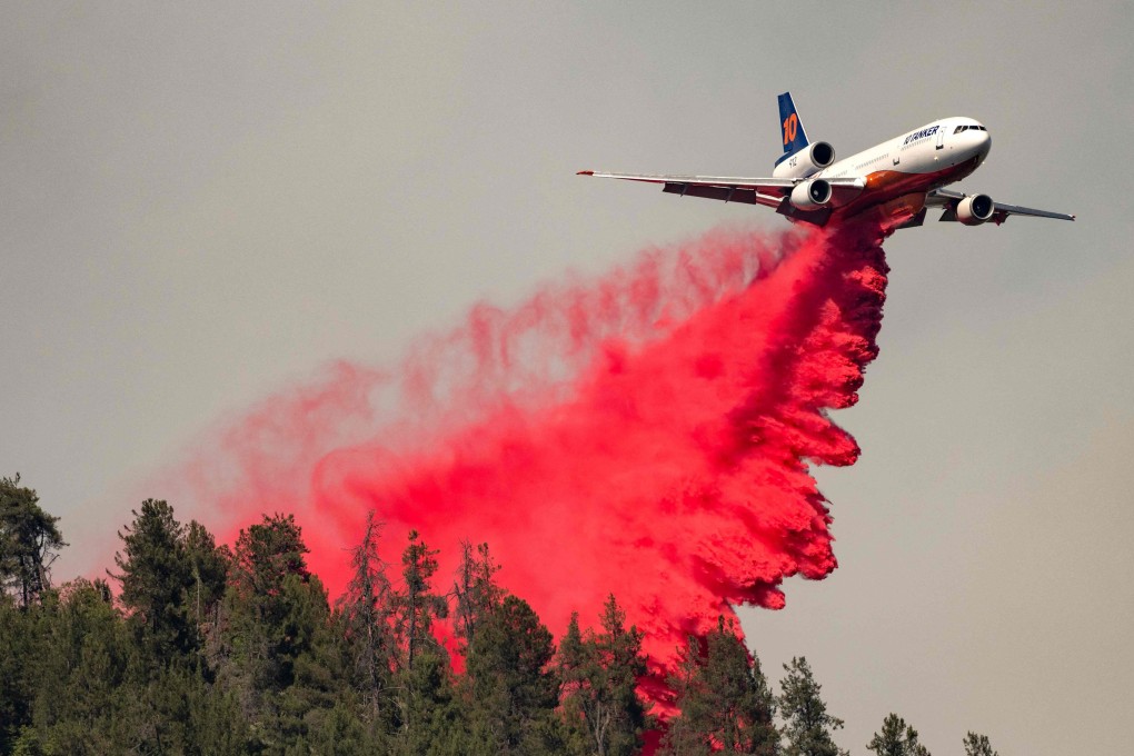 An air tanker drops retardant along a ridge during a fire in Lakehead, California on July 2. As extreme weather events mount, ESG investment is a very indirect and almost certainly ineffective way of funding climate action. Photo: AFP