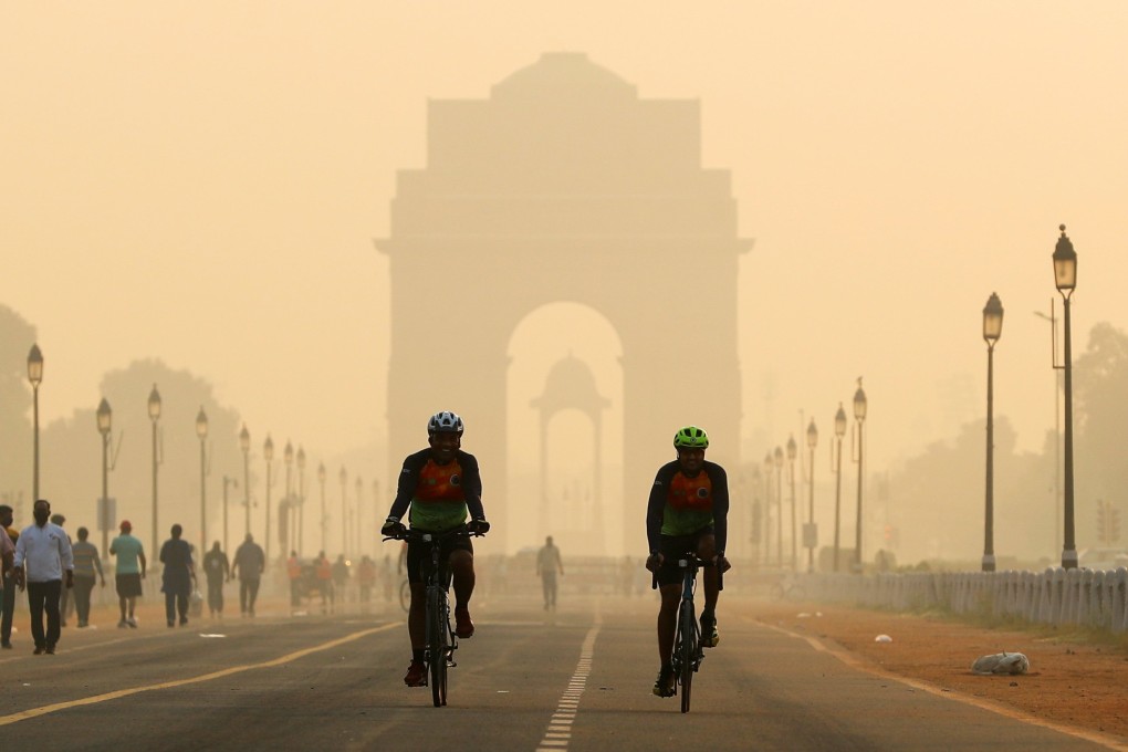 Men ride their bicycles in front of the India Gate shrouded in smog, in New Delhi, India, on October 24, 2020. A UN report projects New Delhi will overtake Tokyo as the world’s most populated mega-city in 2030. Photo: Reuters