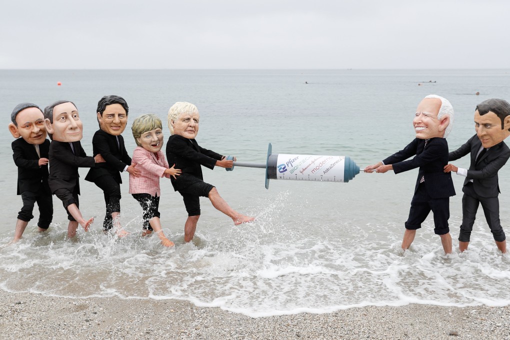 Oxfam activists wearing “big head” caricatures of G7 leaders pretend to fight over a Covid-19 vaccine during a beach-side protest on the sidelines of the Group of Seven summit, in Cornwall, Britain, on June 11. Photo: Reuters