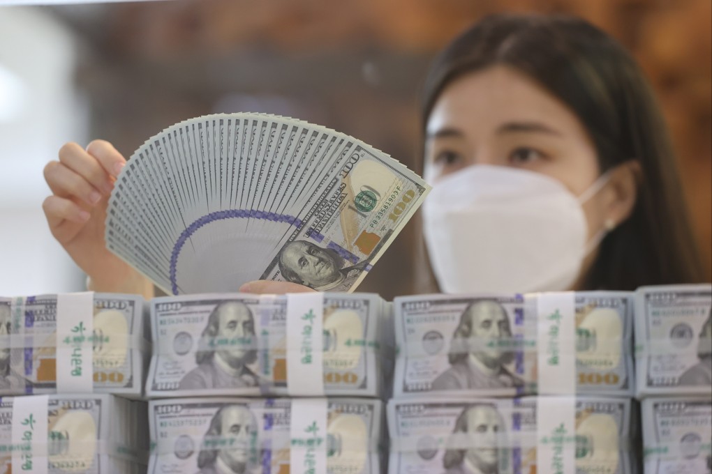 A clerk checks US$100 banknotes at the headquarters of Hana Bank in Seoul, South Korea, on July 5. Photo: EPA-EFE