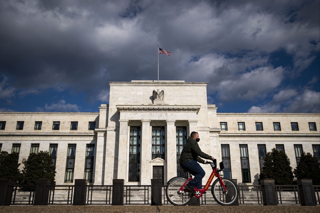 A man rides a bicycle past the Federal Reserve building in Washington on January 22. Photo: Bloomberg
