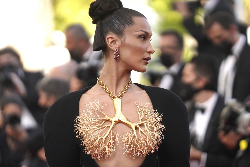 Bella Hadid wears a black dress paired with a gold-dipped necklace in the shape of lungs, both from Schiaparelli, as she arrives for a premiere at the Cannes Film Festival. Photo: AP