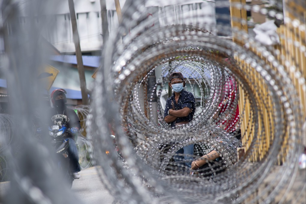 People wait for Covid-19 swab tests in an area where movement control measures are in place in Kuala Lumpur on July 3. Photo: Xinhua