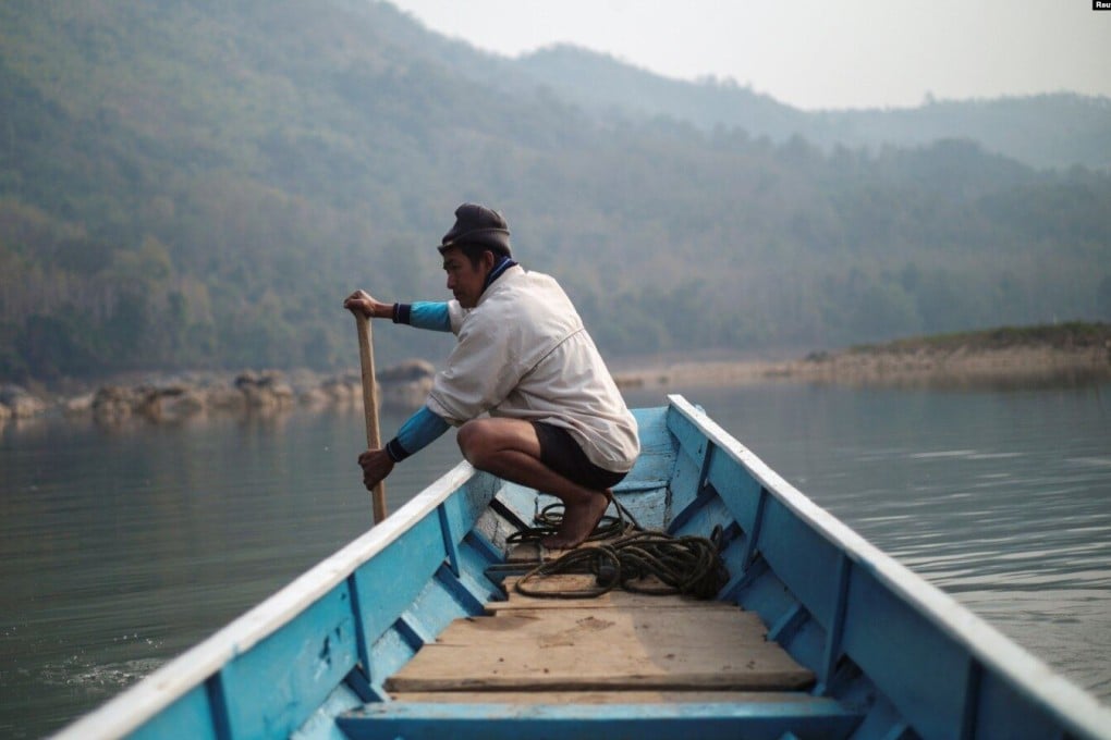 A local villager drives a boat where the future site of the Luang Prabang dam will be on the Mekong River, on the outskirts of Luang Prabang province, Laos, on February 5 last year. Photo: Reuters
