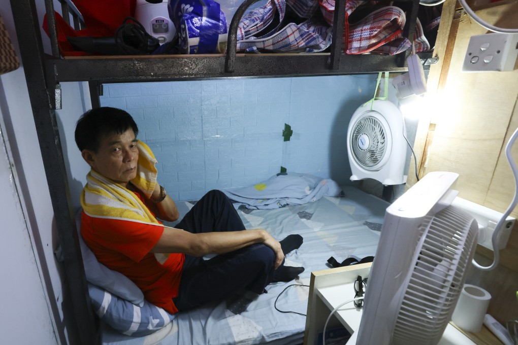 Wong Kwong-wah, seen here in a photo taken on July 10, lives in a windowless 30 sq ft room in Sham Shui Po, and needs to turn on two fans in hot weather. Subdivided flats are cheaper to rent in absolute terms but are more expensive on a per square foot basis. Photo: Dickson Lee