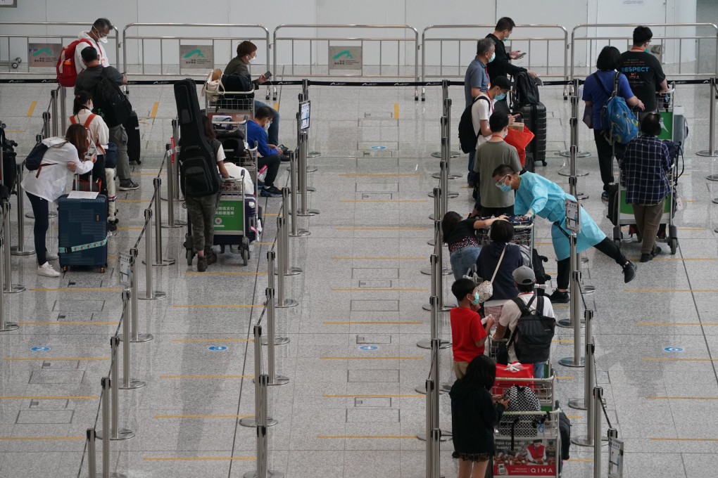 Arriving travellers wait to be transported to quarantine hotels at Hong Kong airport on June 30. Photo: Felix Wong