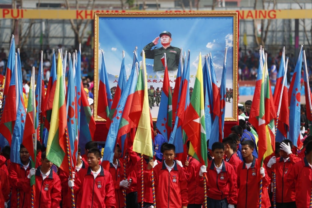 People hold a portrait of Wa State’s leader Bao Youxiang during a ceremony to mark the 30th anniversary of Wa State on April 17, 2019. Photo: EPA-EFE