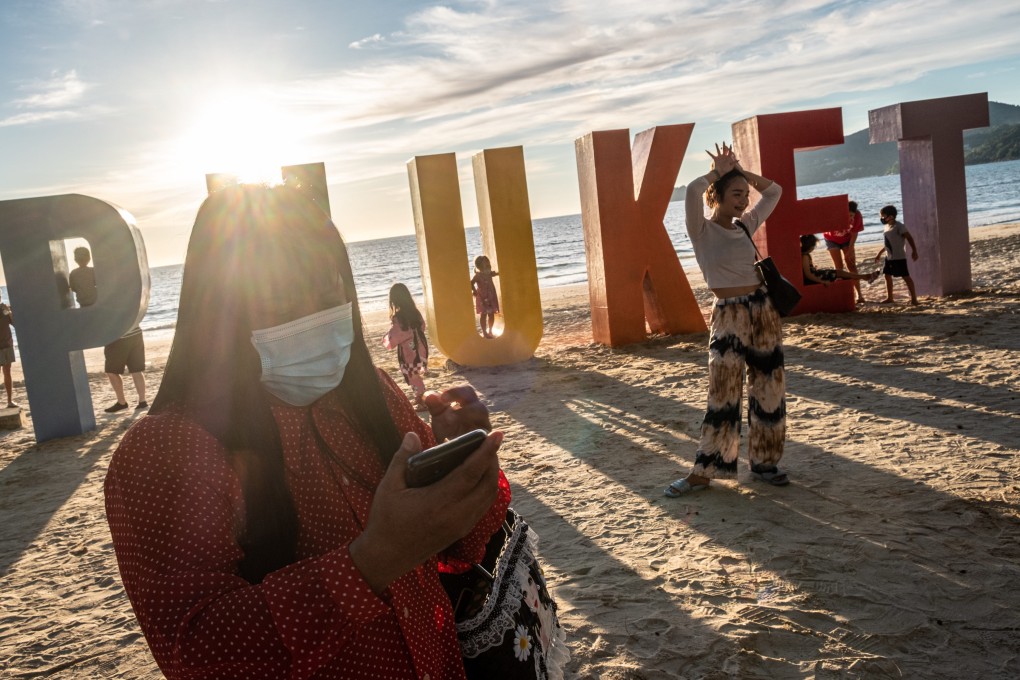 Locals and tourists attend an event organised to mark the opening of Phuket to international tourists on Patong beach. What will it take for Bali in Indonesia, which has seen day after day of record-breaking new case numbers, to reopen? Photo: Getty Images