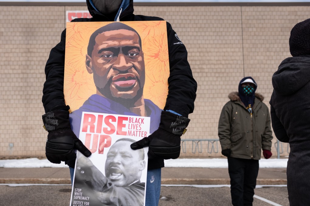 A protester holds a poster of George Floyd during a rally in St. Paul on Martin Luther King Jr. Day. January 18, 2021.  Photo by Tim Evans/NurPhoto via Getty Images