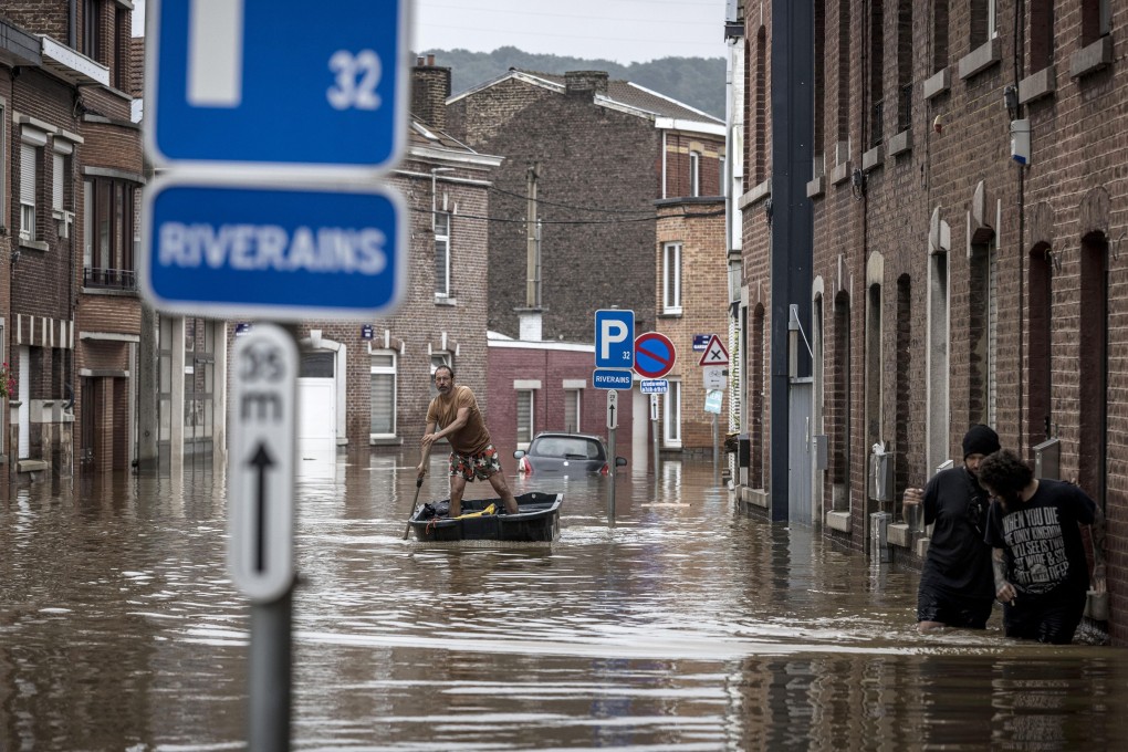A man rows a boat down a street after flooding in Liege, Belgium, on July 16. Severe flooding in Germany and Belgium has killed scores and turned streams and streets into raging torrents that swept away cars and caused houses to collapse. Photo: AP