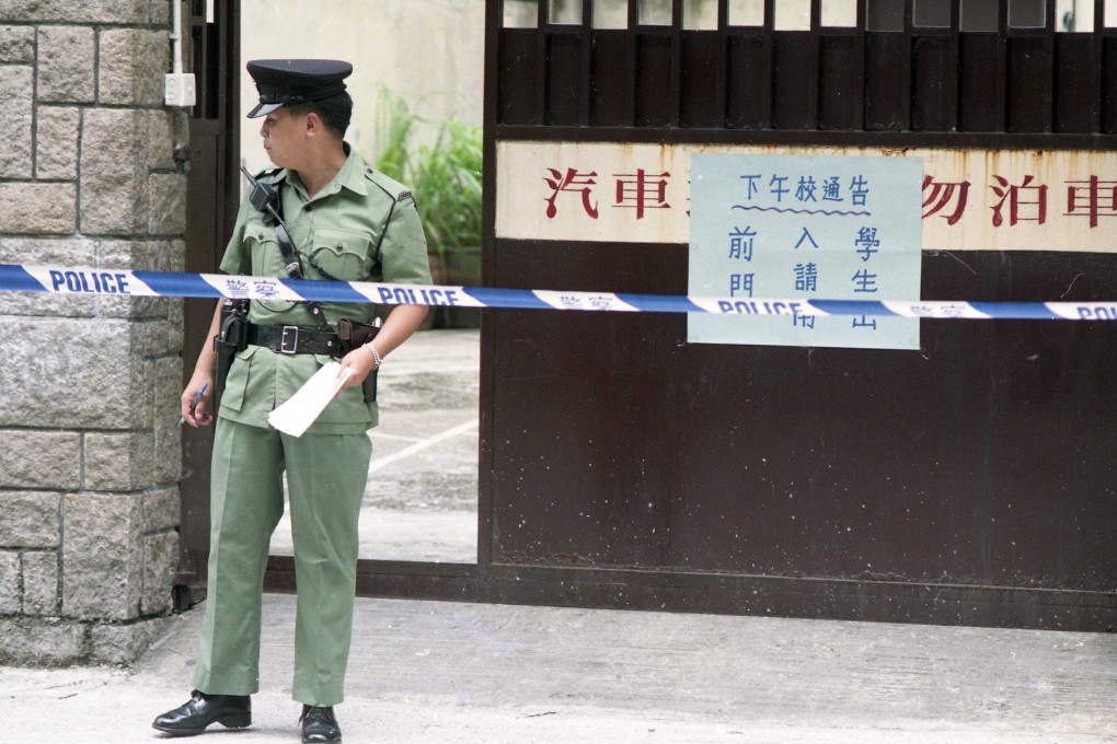 Police officers cordon off a crime scene at Good Shepherd Primary School, in To Kwa Wan in 1993. The headmaster of the school was arrested for the death of a school accounts clerk. Photo: Martin Chan