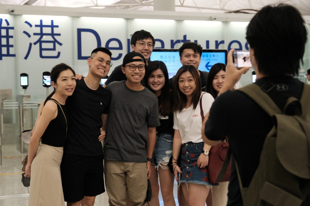 A farewell photograph before a flight to London from Hong Kong taken on July 1. They have become a common sight in recent months. Most of those leaving are young, and many have children. Photo: Edmond So