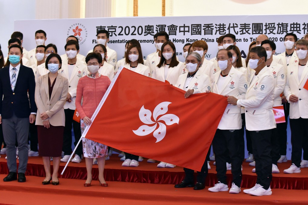 Hong Kong’s Chief Executive Carrie Lam Cheng Yuet-ngor (in pink blouse, first row) and sports chief Timothy Fok Tsun-ting (first row, third right) pose with members of the Hong Kong delegation during a flag presentation ceremony for the Tokyo Olympic Games, at Government House on July 8. Photo: Xinhua