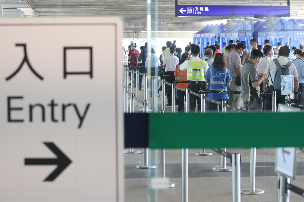 Airport staff subject to compulsory testing queue up for Covid testing at a mobile specimen collection station  in Terminal 1 of the Hong Kong International Airport on July 13. Photo: Nora Tam
