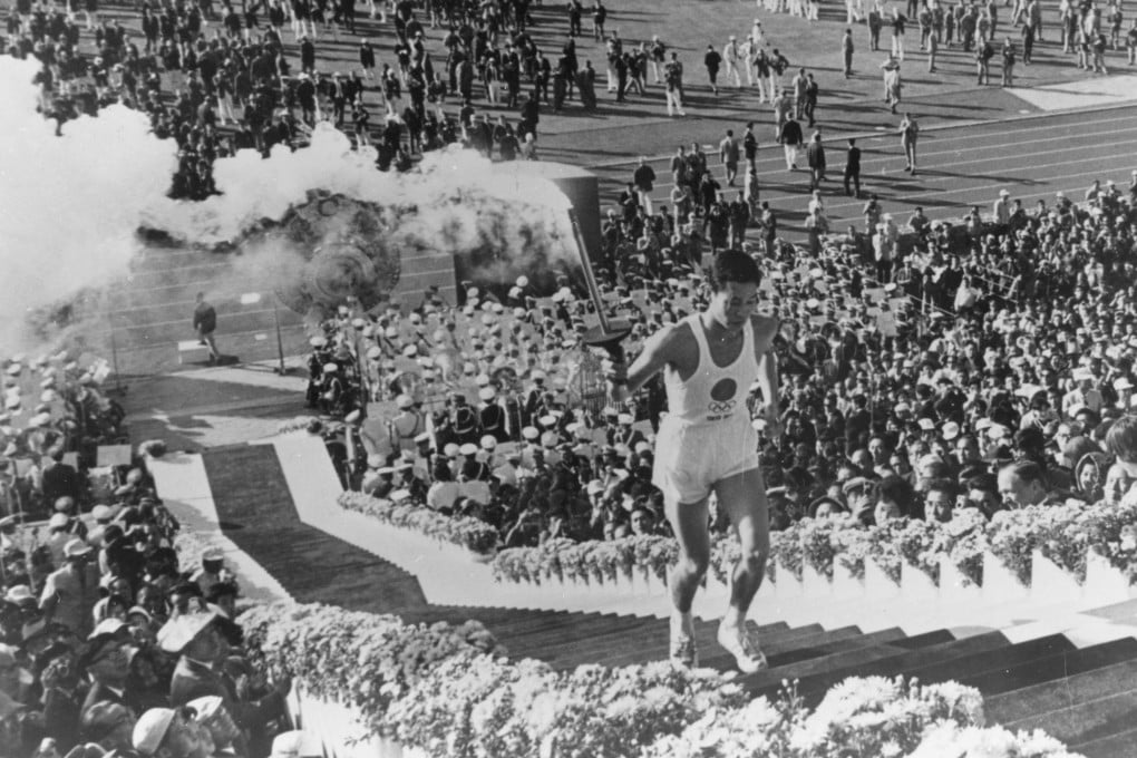 Yoshinori Sakai, a student born in Hiroshima on the day the first atomic bomb devastated the city, during the opening ceremony for the 1964 Tokyo Olympics. Photo: Getty Images