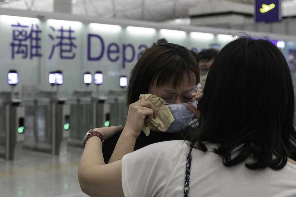 A woman weeps as she says goodbye to her friend at Hong Kong International Airport on July 17. Photo: SOPA Images via ZUMA Press Wire/dpa