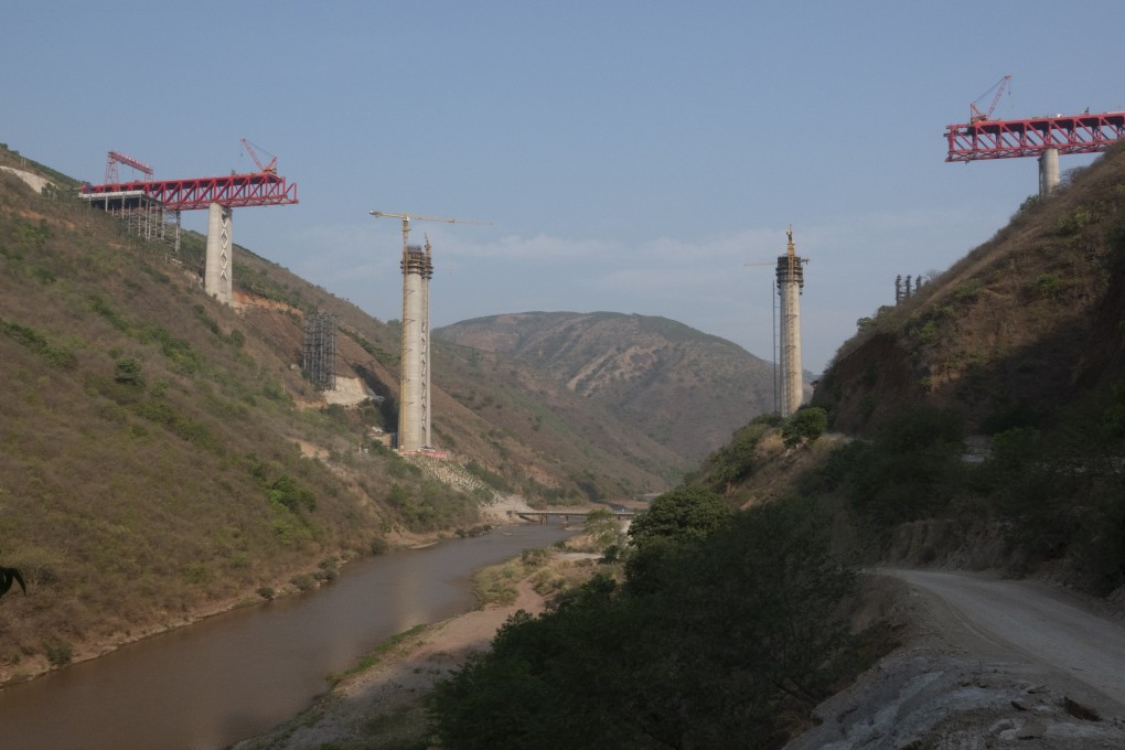 Construction work under way on a bridge carrying the China-to-Laos railway. The opening of the line and a north-south highway will change tourism in Laos by making it easier to travel to and within the country. Photo: Getty Images