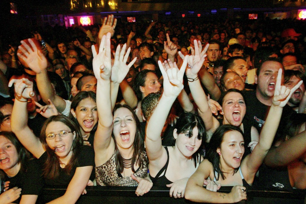 Fans react at a Papa Roach concert. Celebrity crushes are usually associated with screaming teenage girls at film premieres or concerts, but adults have them too. Photo: Getty Images