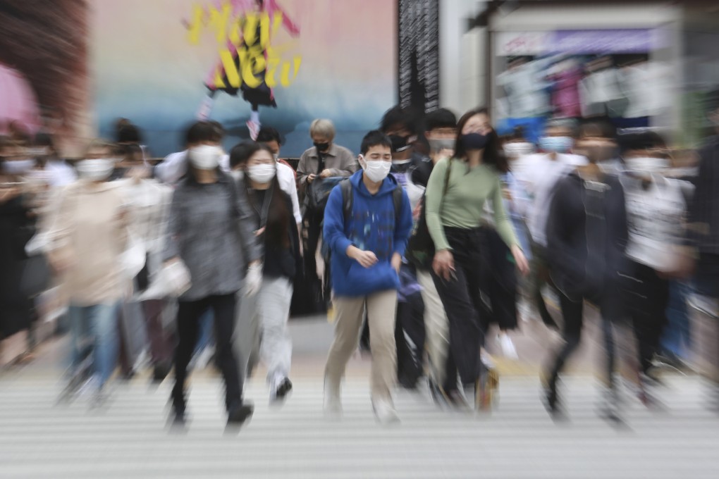People wearing masks cross a street in Tokyo, Japan, on May 18. A nation which once seemed poised to become the world’s leading economic power has instead seen export volumes fall despite a weak yen. Photo: AP