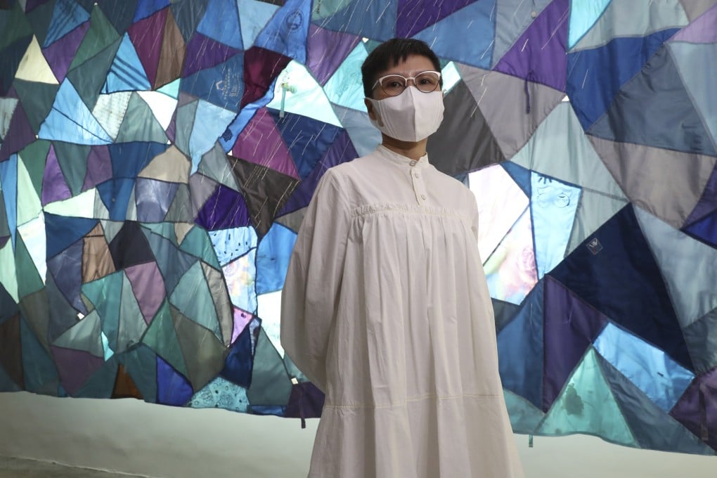 Artist Jaffa Lam in front of her arwork “A piece of cityscape, 2021”, made by sewign together scraps of umbrella fabric, at” Residual Heat”, an exhibition at Axel Vervoordt Gallery in Wong Chuk Hang. Commercial galleries are, unusually, showing work by Hong Kong artists. Photo: Edmond So