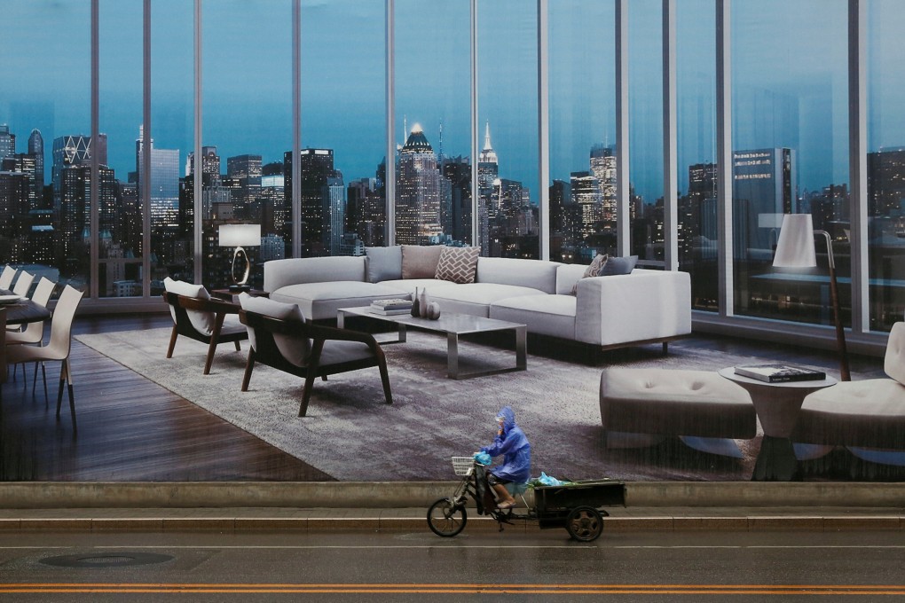 A man rides a tricycle past an advertising poster for luxury apartments in Beijing in July 2016. Unlike in the West, the pandemic has accentuated the appeal of urban living in Asia, a crucial driver of the region’s economic growth. Photo: Reuters