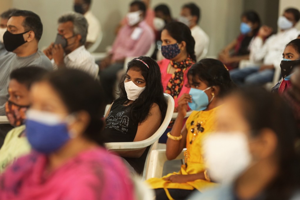 People in Bangalore, India, attend an event on July 25 disbursing scholarships to children who lost their parents to Covid-19. Photo: EPA-EFE