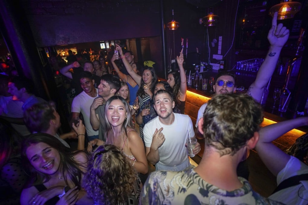 Revellers in London react on the dance floor shortly after the reopening at midnight on July 19. Thousands of young people danced the night away at “Freedom Day” parties as almost all coronavirus restrictions in England were scrapped. Nightclubs had been closed since March 2020. Photo: AP